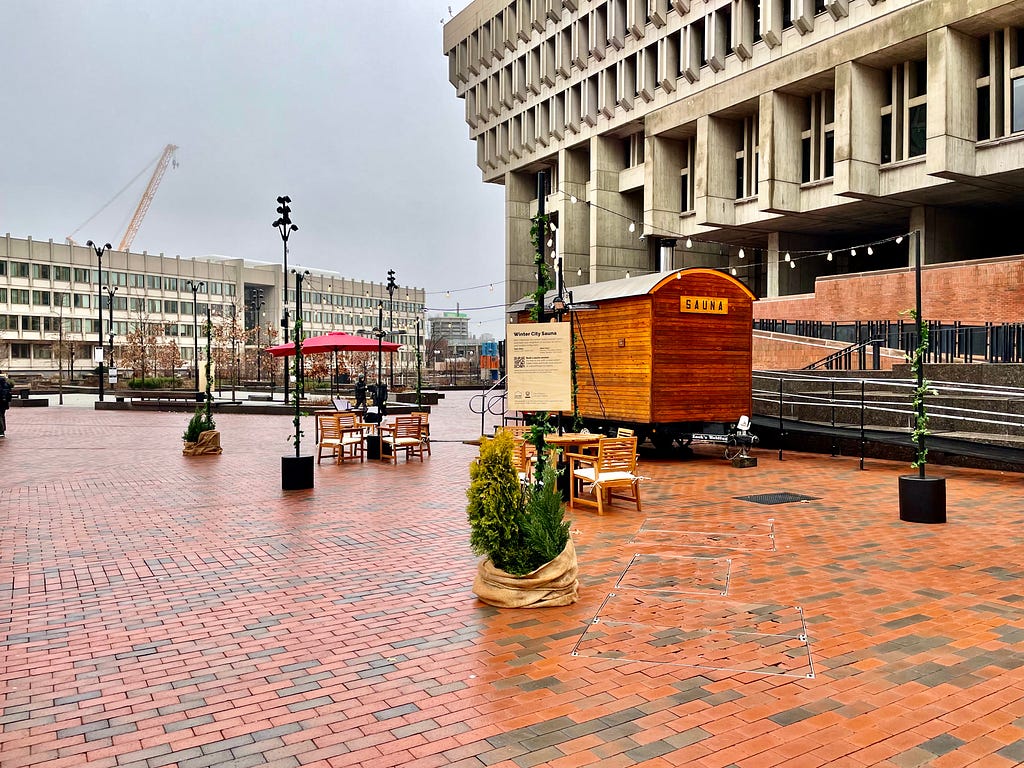 A mobile pop-up sauna and seating area on Boston’s City Hall Plaza.