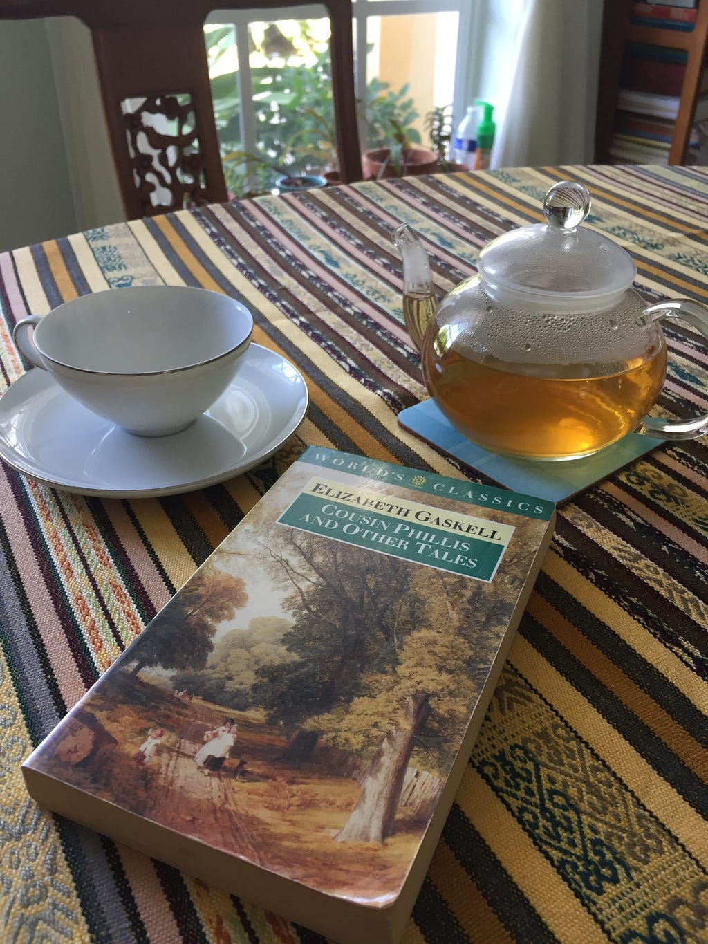 A teacup, teapot and a book