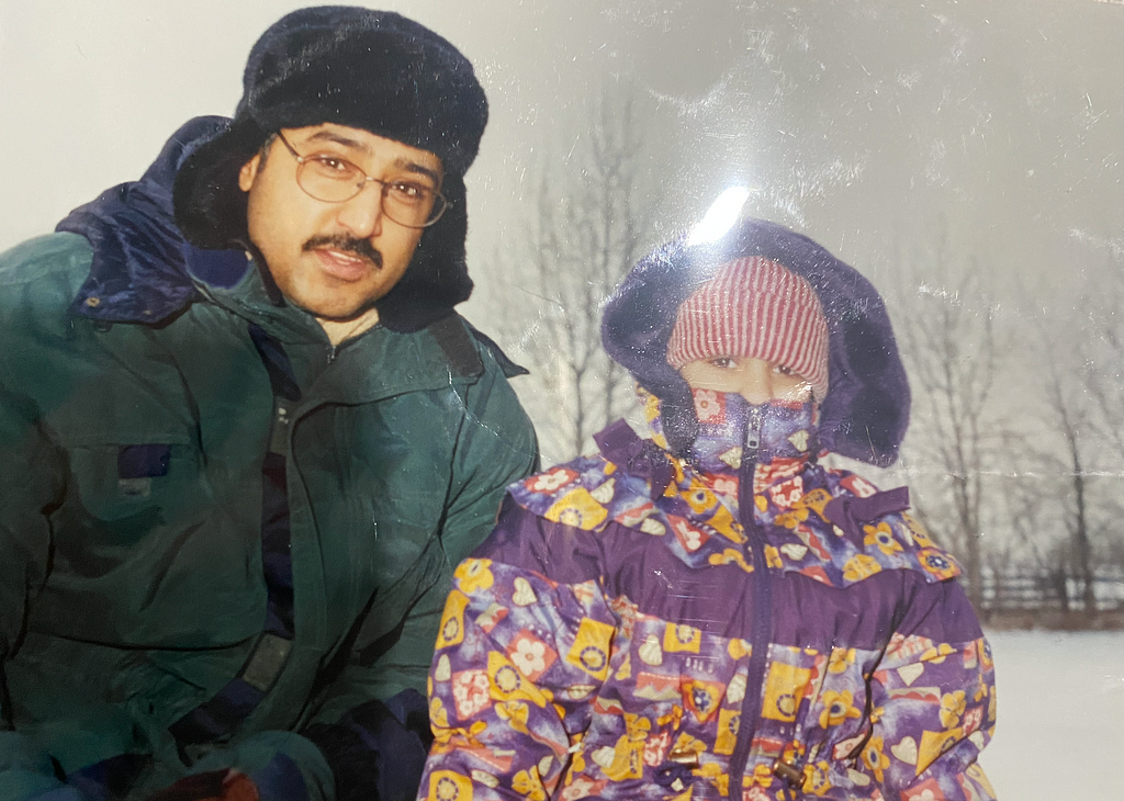 Sohi and his daughter Seerat in 80’s winter coats outside.