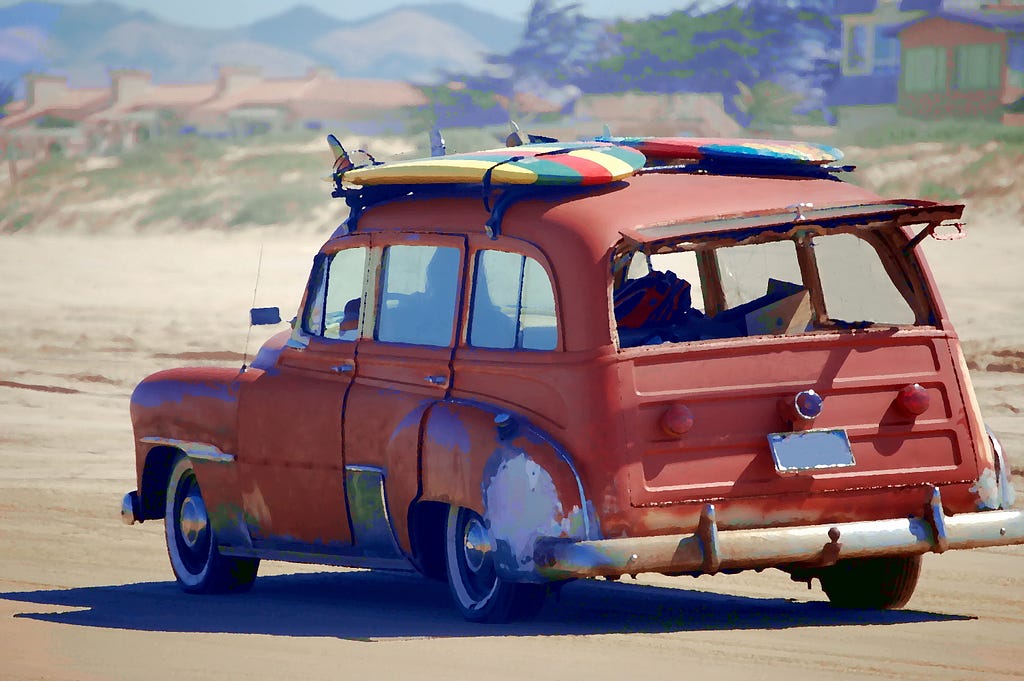 An old jalopy that is carrying surf boards to the beach even after all these years.