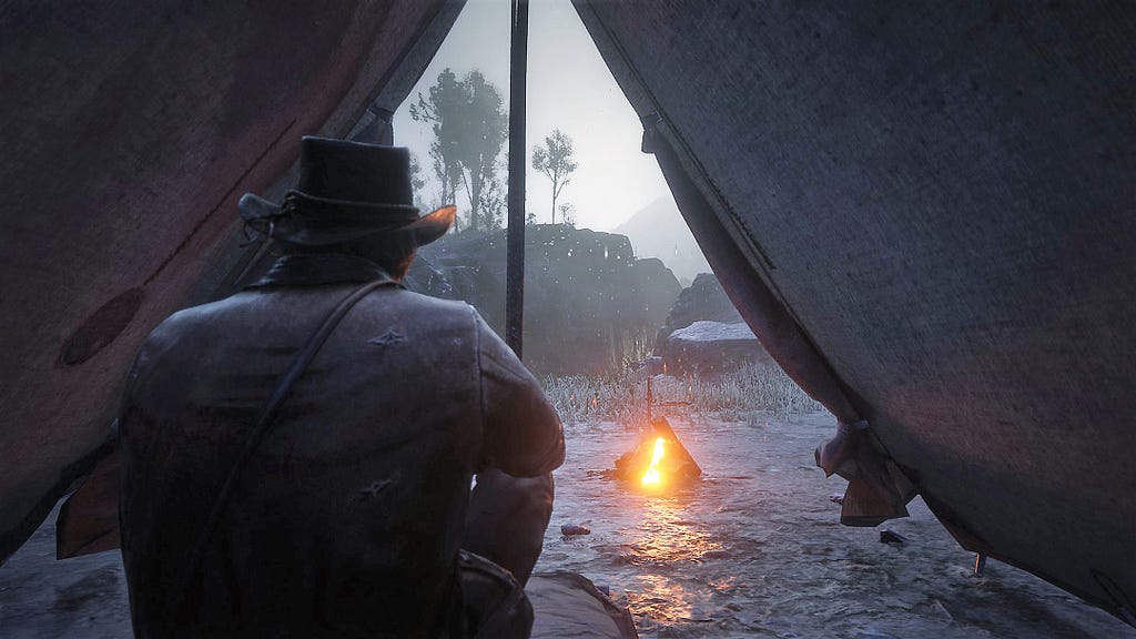 Arthur sitting inside a self-made tent as it rains heavily outside