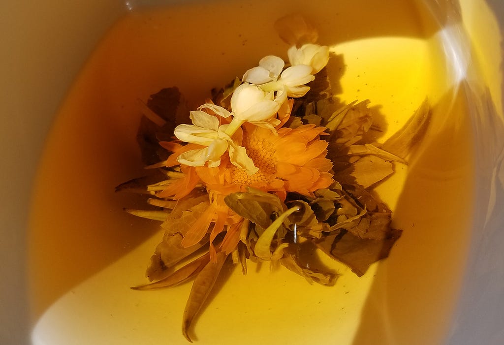 Photo of blooming tea in a cup.