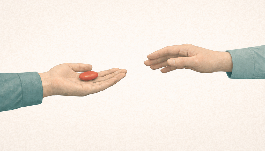 Two hands across a frame, one offering a small coral-colored object on an open palm, the other reaching toward it with an empty hand