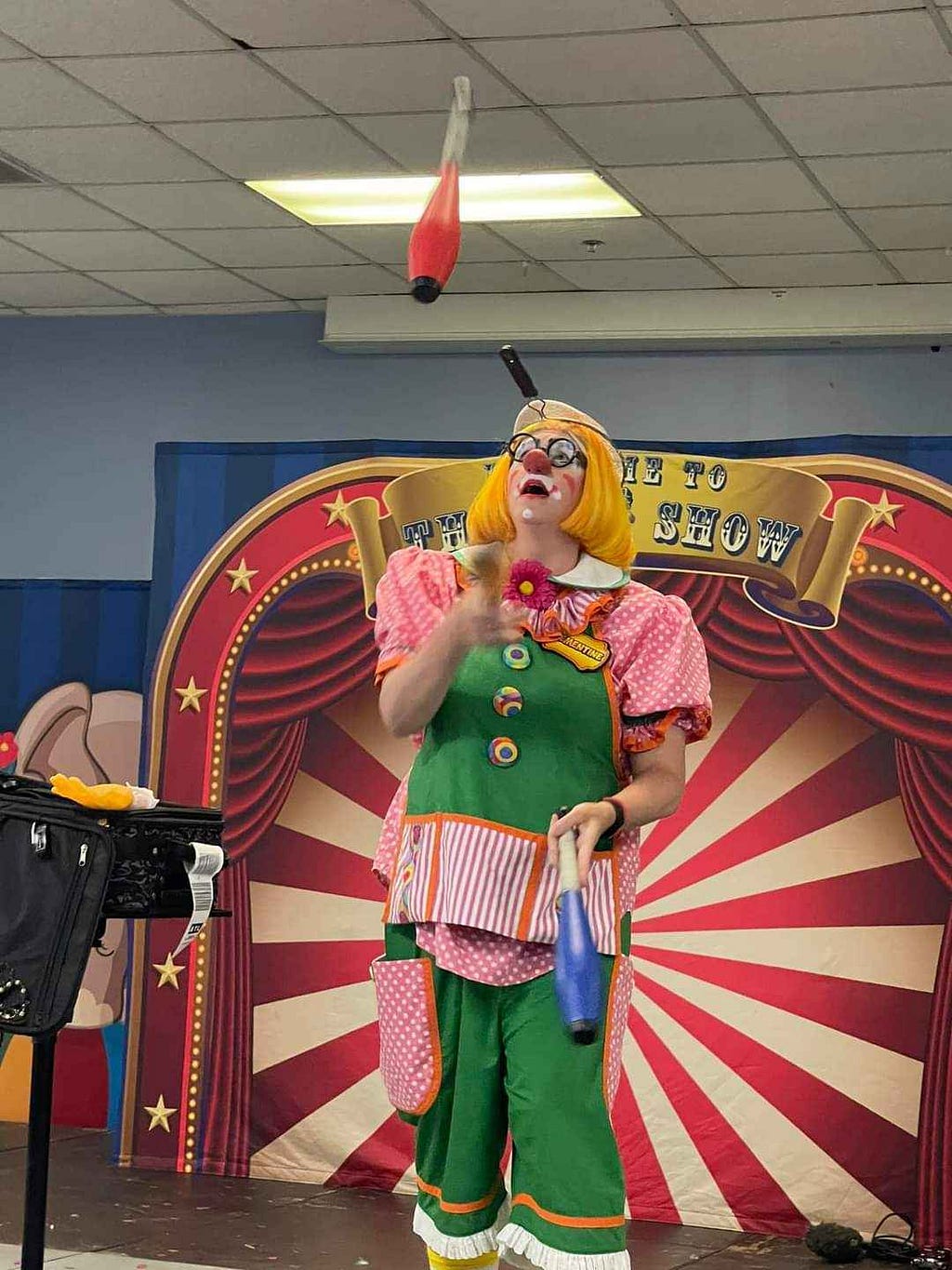 Clown juggling with a colander on her head as a helmet. Picture taken at the Academy of Clown Arts Camp, which Clementine highly recommends for those interested in growing their clowning.