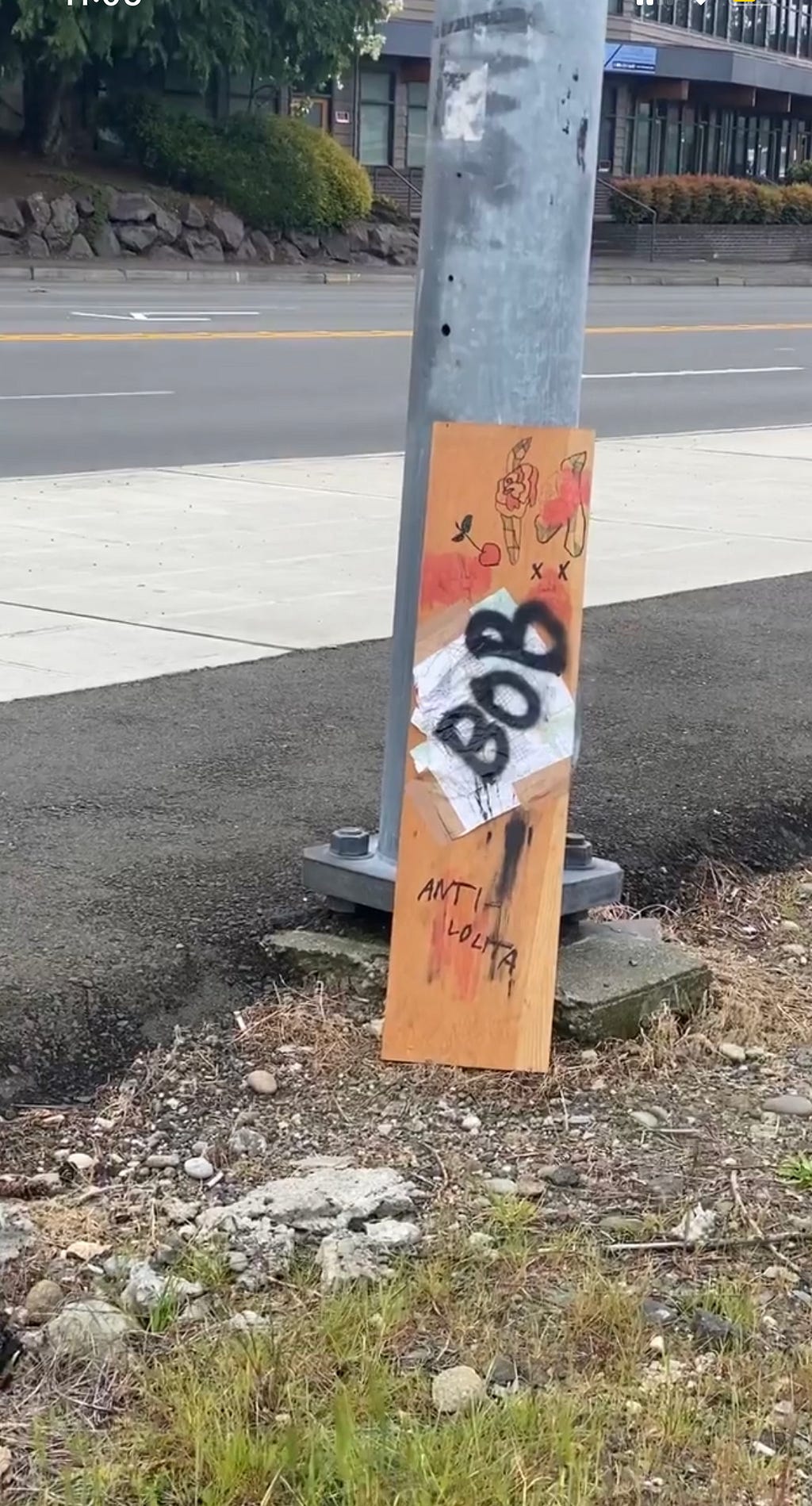 multimedia painting leaning on street sign