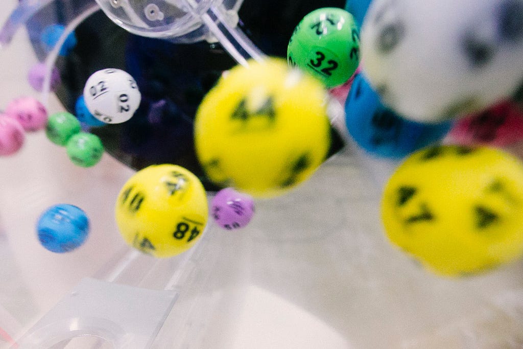 Multi-colored dice bounce after being thrown