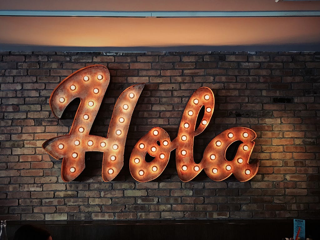 A text called “Hola” on the wall