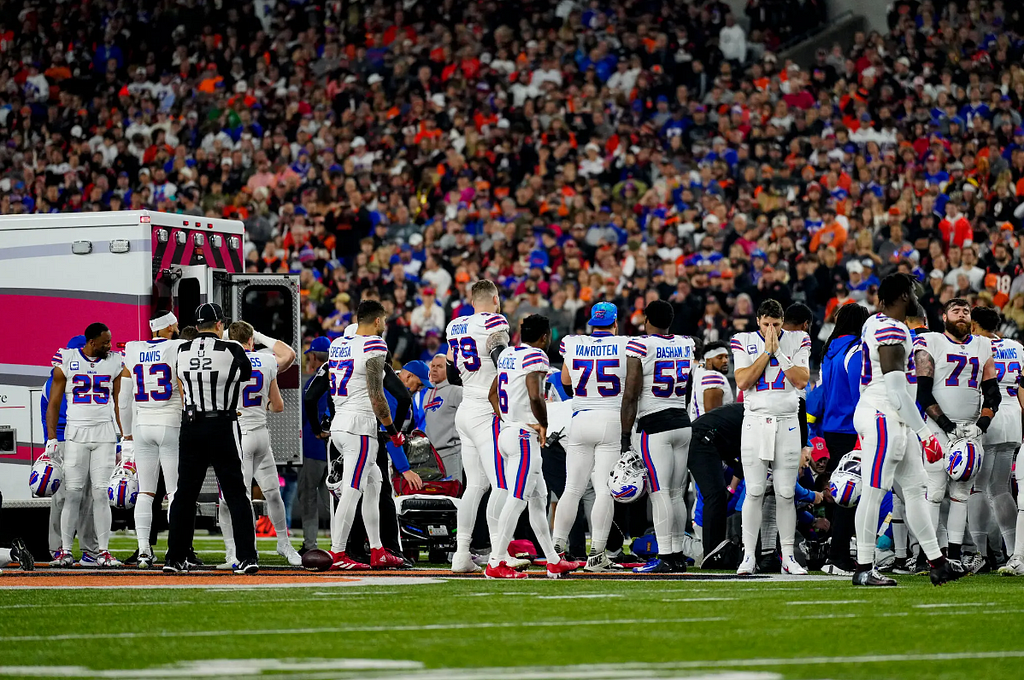 Buffalo Bills players surrounded their teammate Damar Hamlin as he was treated at Paycor Stadium in Cincinnati.Credit…Sam Greene/USA Today Sports, via Reuters