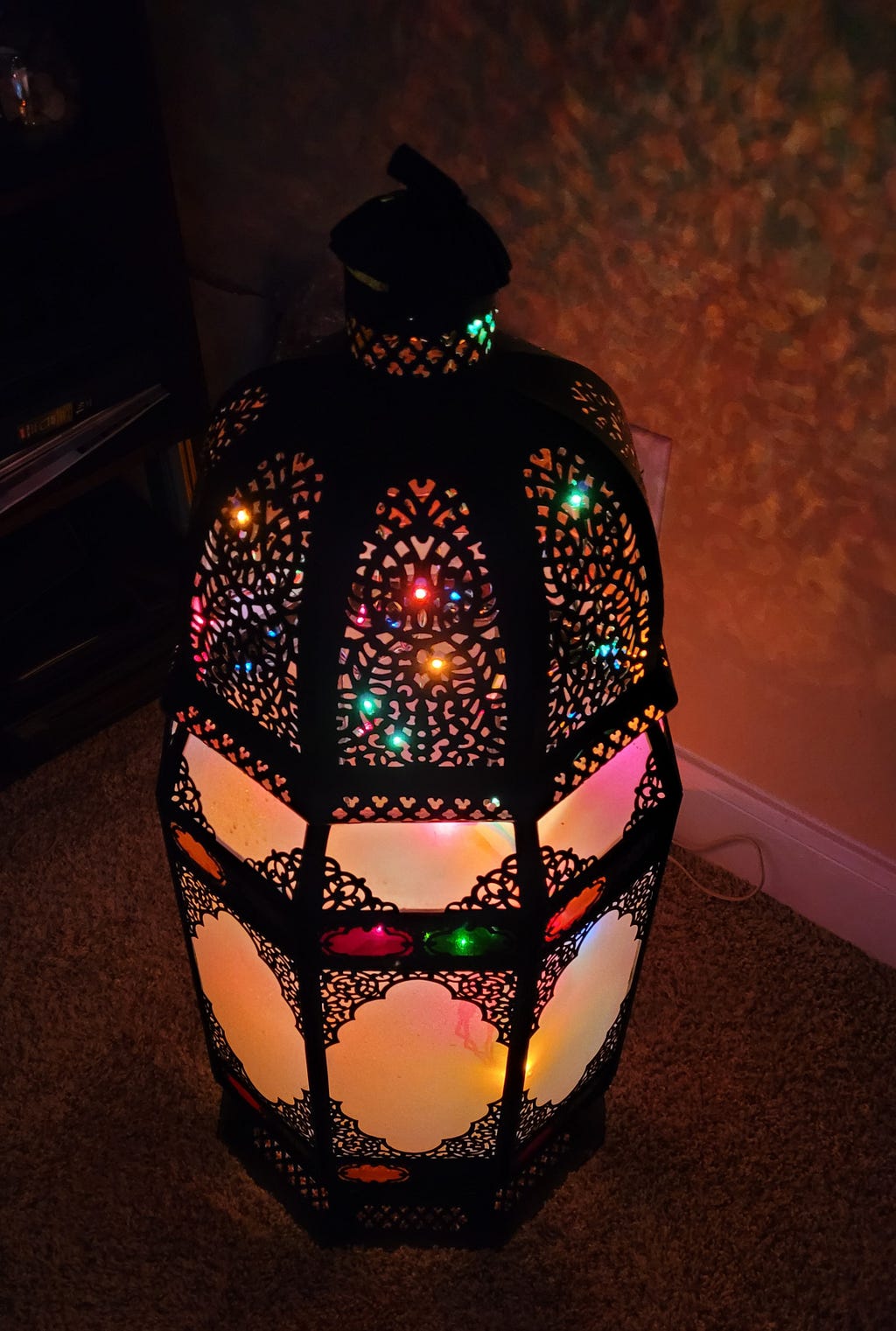My traditional Ramadan lantern, which is made of glass panes framed in metal arabesque motifs, is lit from within with Christmas string lights.