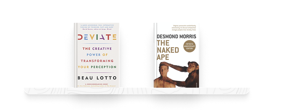 A bookshelf with two books. On the left is Deviate by Beau Lotto, on the right is The Naked Ape by Desmond Morris