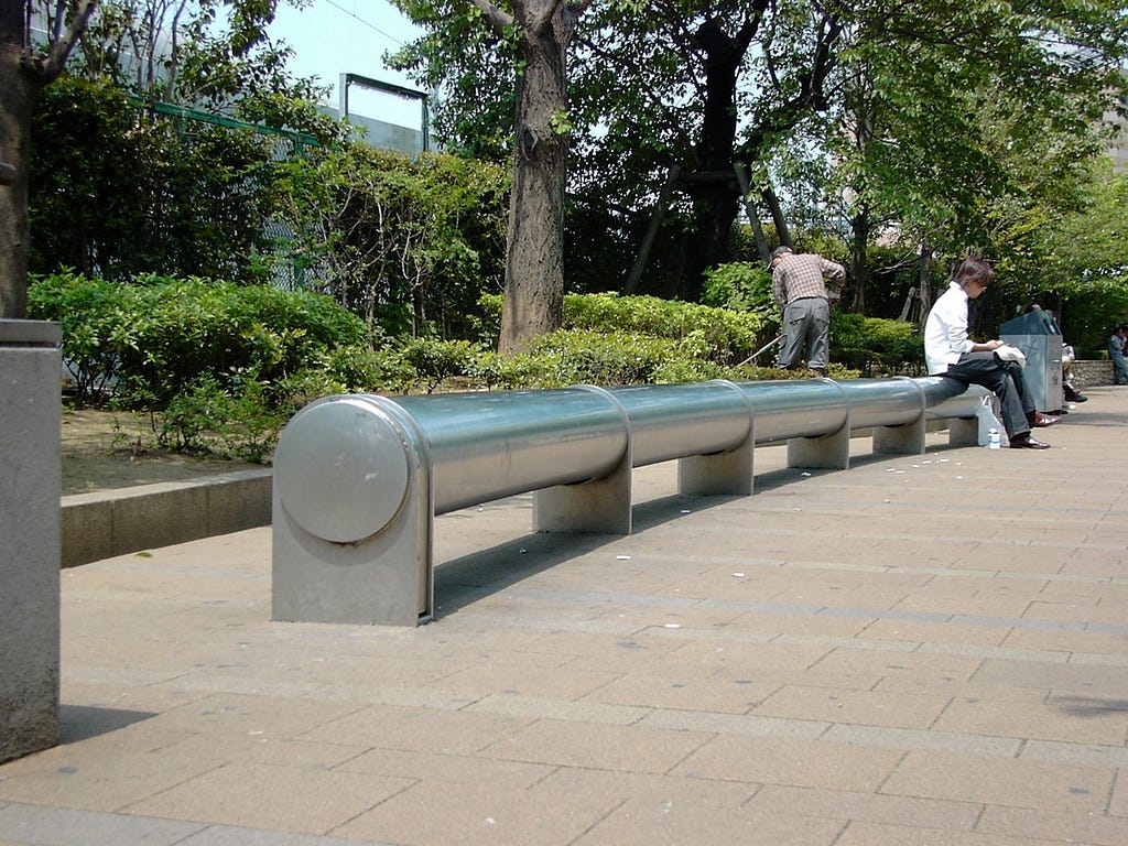 A long metal cylindrical tube on its side to be used for seating