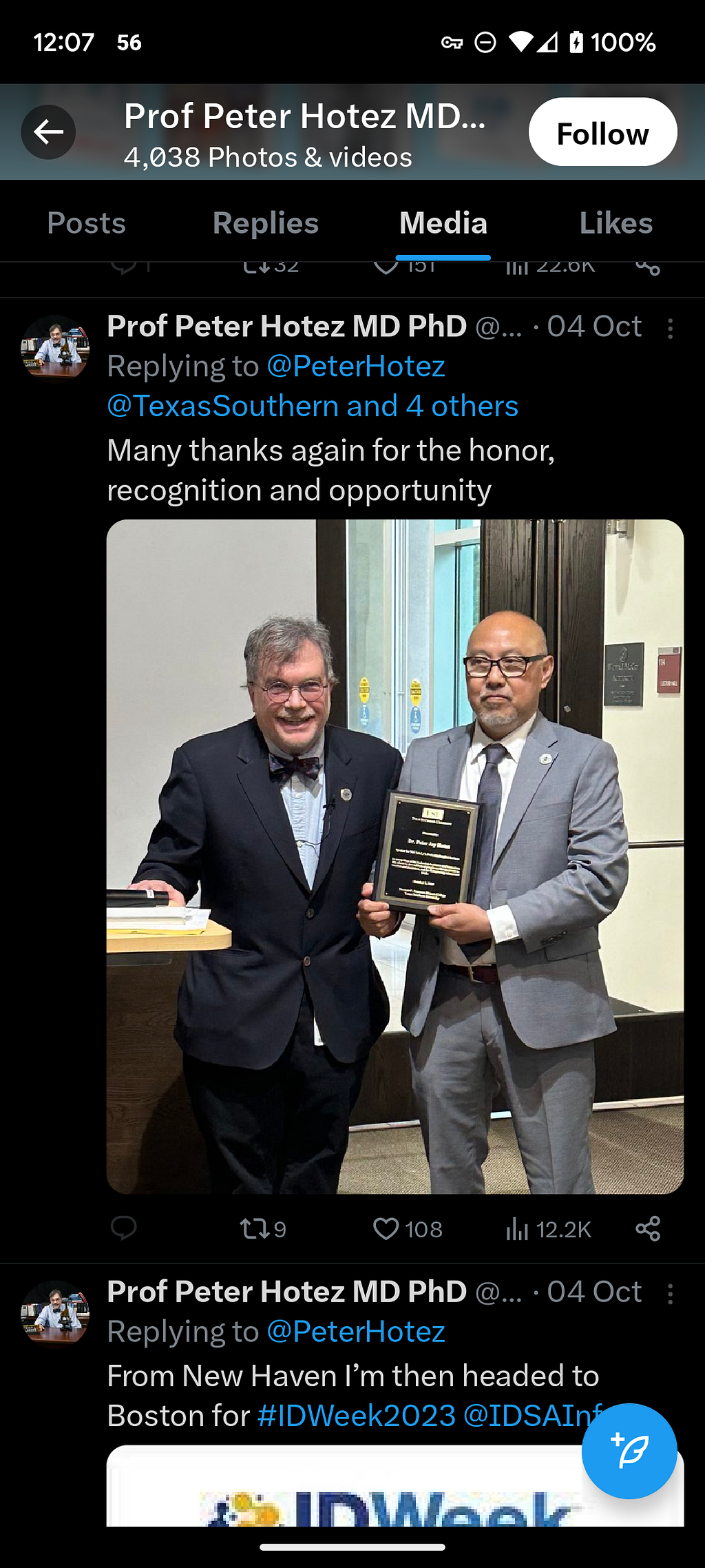 Peter Hotez in a Twitter photo posing for an award, maskless.