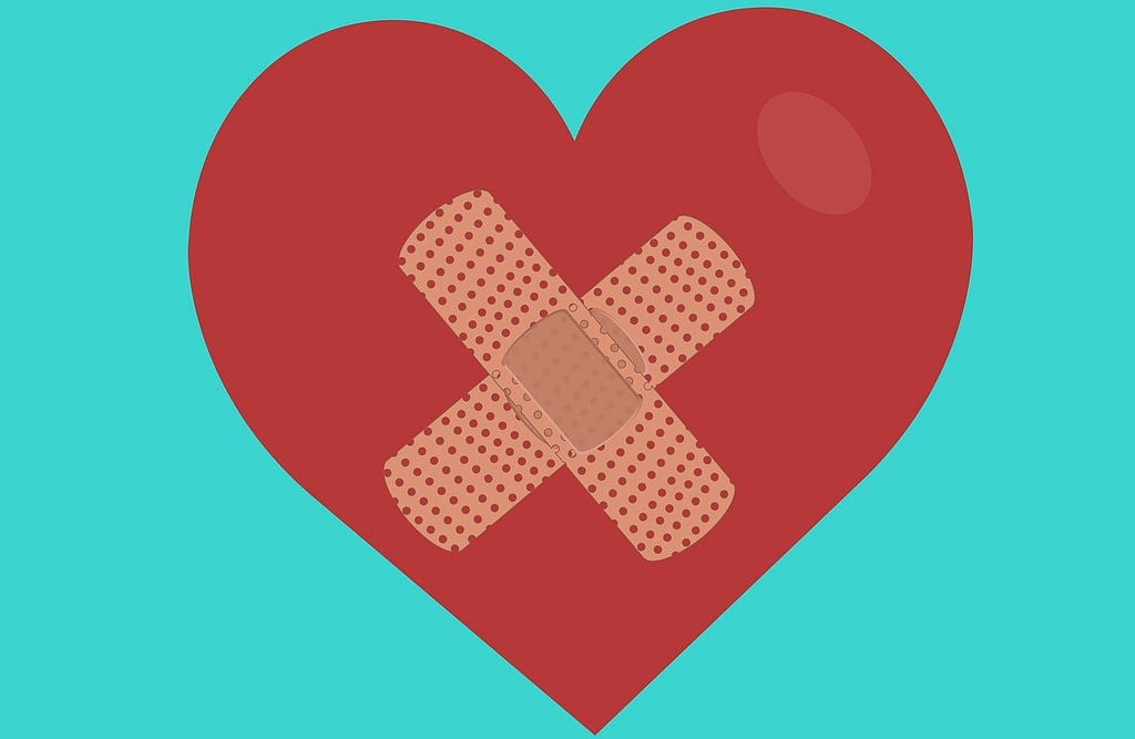 Illustration of a red heart on a teal background. There are two bandages crisscrossing the center of the heart.