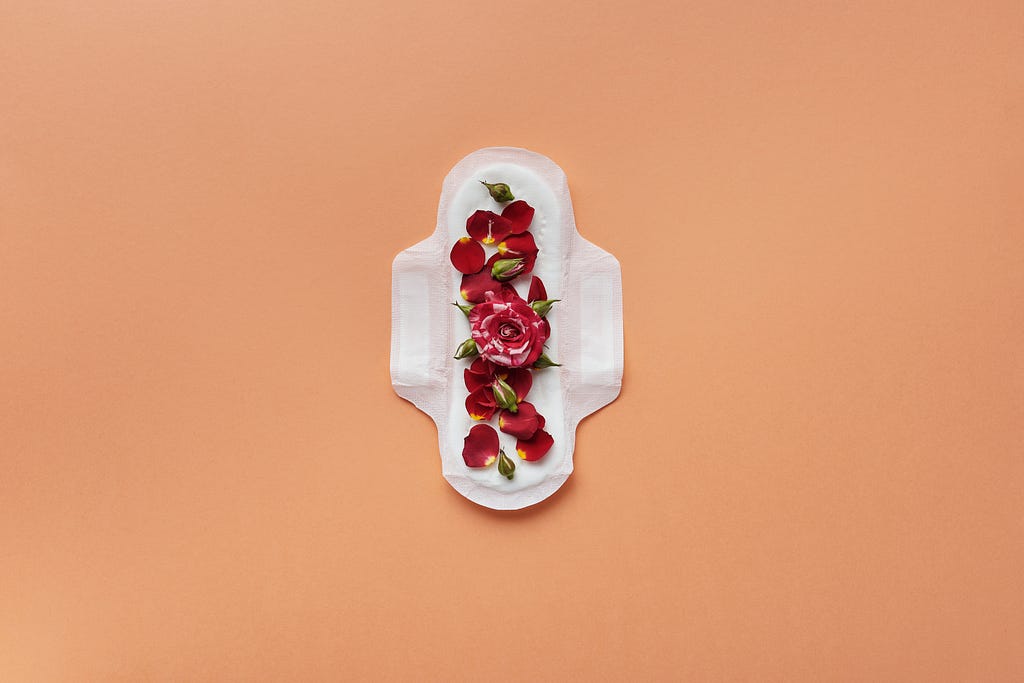 Woman’s feminine hygiene product with rose petals