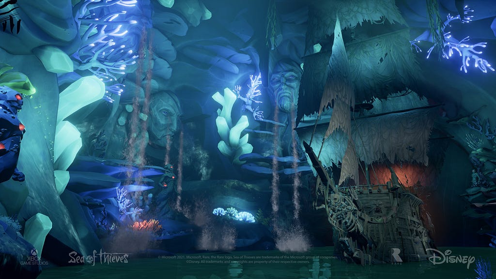 A cavernous chamber with a variety of glowing coral-like structures and scultures of faces on the walls, and a ghostly pirate ship floating in the water.