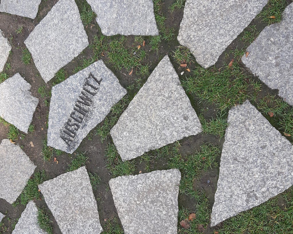Pavement depicting Auschwitz on a cobblestone.