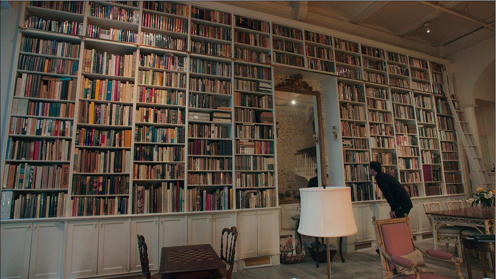 Image of a large wall of books from the film The Bookseller