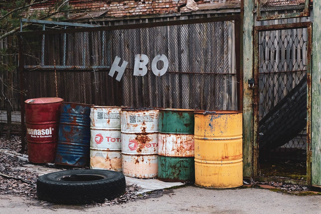 A street art image showing some barrels with a sign above them spelling HBO