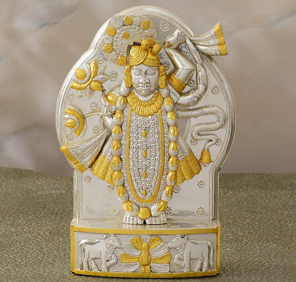 Explore the Elegant Silver Shrinathji Idol with a golden leafs, showcasing Symbol of Devotion and Grace