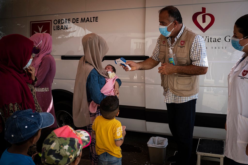 In the area of Khaldieh towards Tripoli, the poorest city in Lebanon, Lebanese and Syrian refugee families are waiting to be received at the medical bus of the Order of Malta NGO, August 2021. Photo by Didier Bizet/Hans Lucas via Reuters