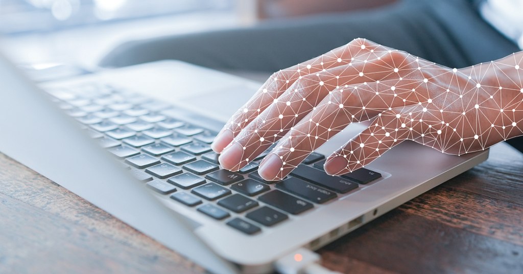 digital hands on a computer keyboard