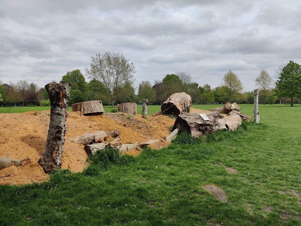 Insect bank, made of logs, sand and rocks, in a typical public green park.