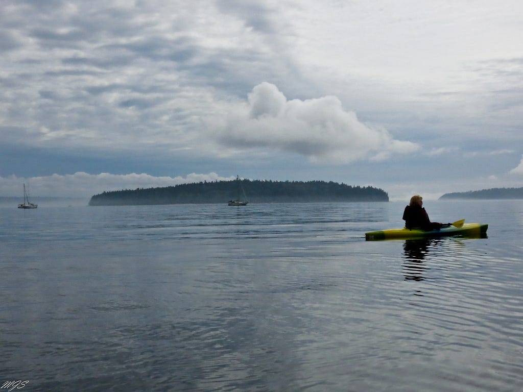 Photo of kayaker and boats near Blake Island in WA. Photo credit: Mark Smith.