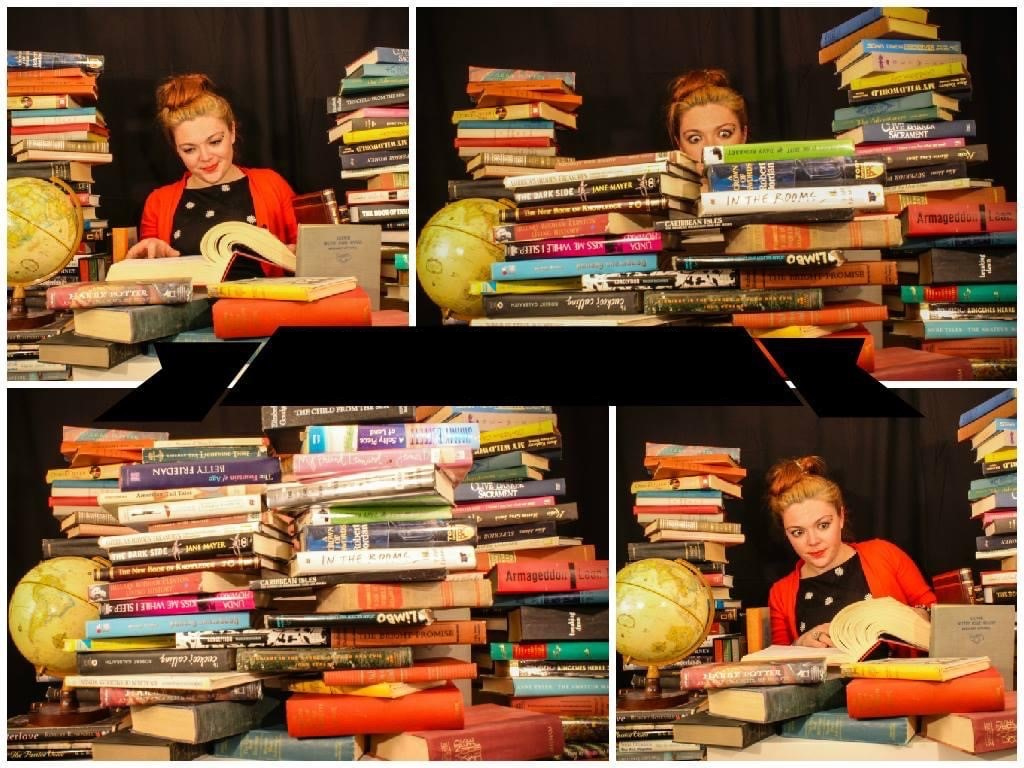 Woman behind desk that is being filled with books.