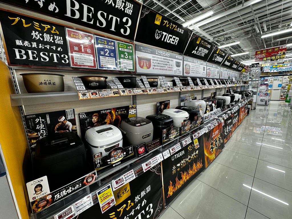 A Japanese department store with shelves of various rice cookers