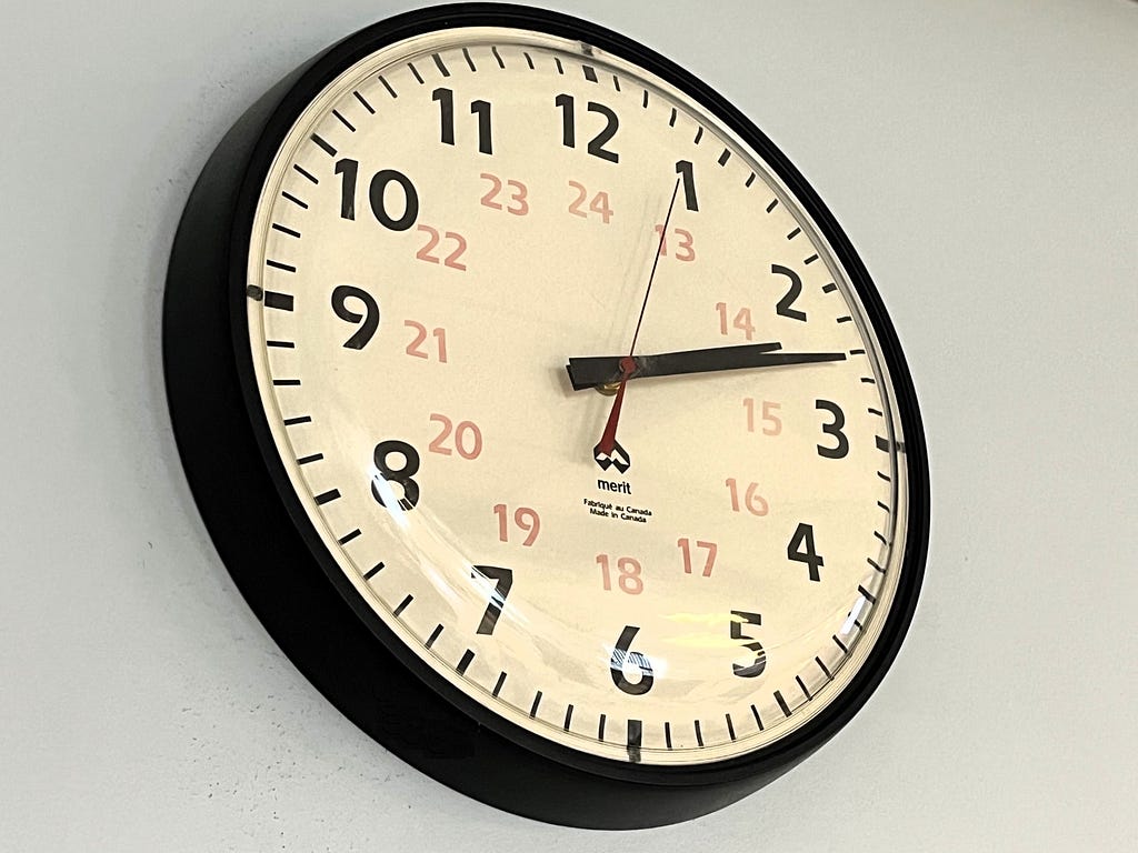 An office-style wall clock indicating a time of 2:12.