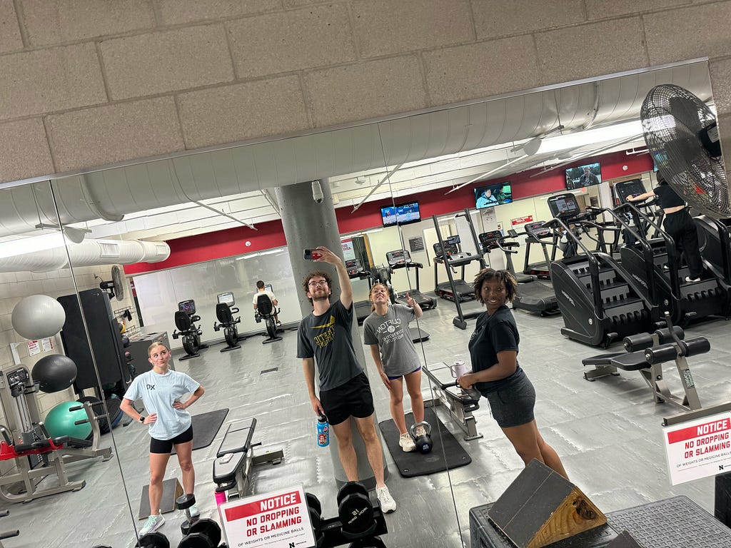 Jameson takes a photo of him and other leaders at the gym
