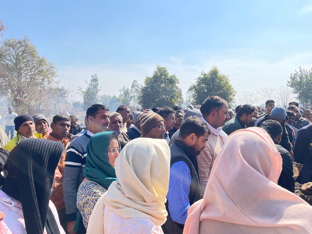 A group of people outdoors facing the same direction.