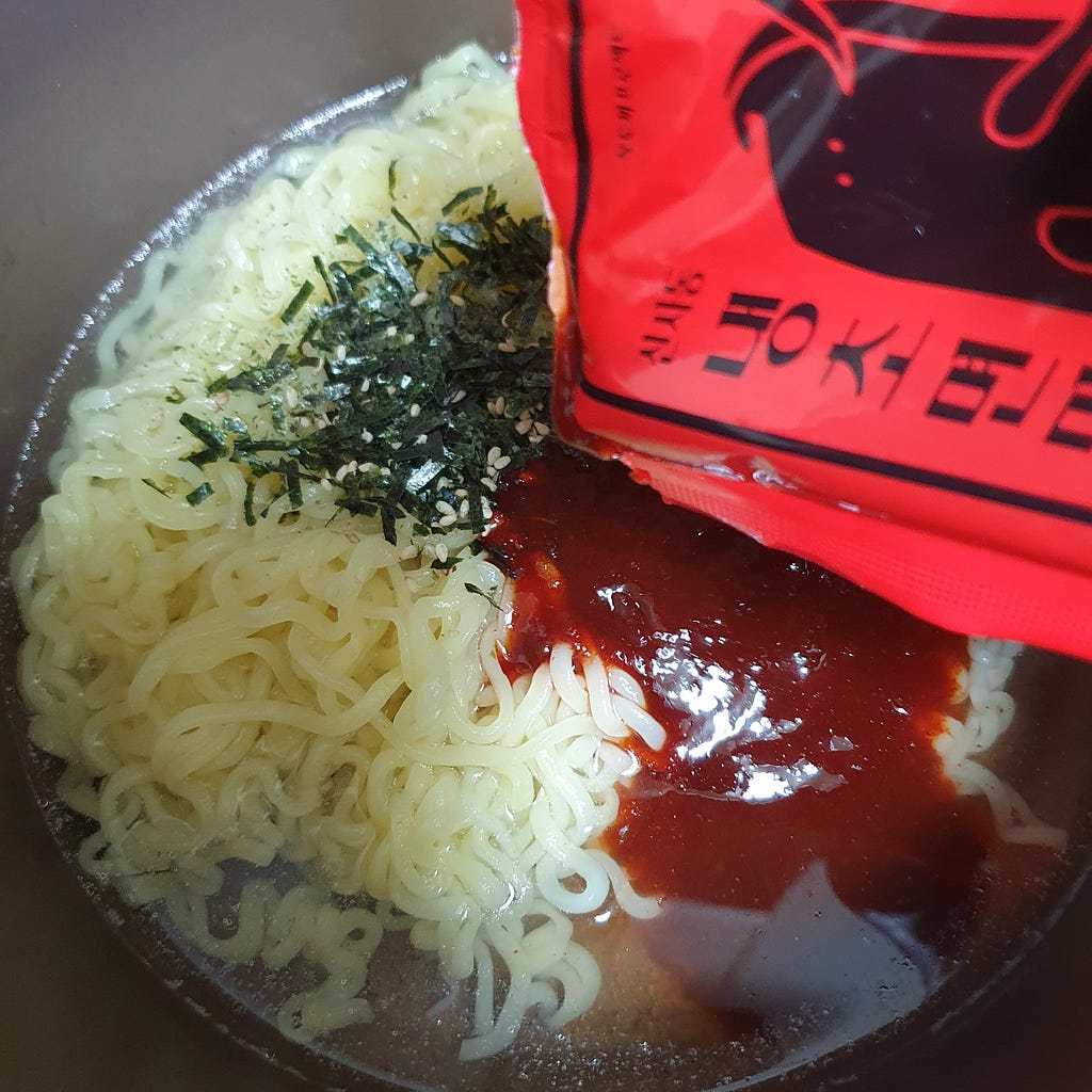 Mixing both the packet of laver and sauce packet with the noodles from a package of Wicked Ramen (Yogoe Ramyeon) Shinsadong Naengcho-Myeon Flavor.