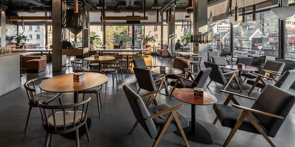 Image of a café room filled with tables and chairs
