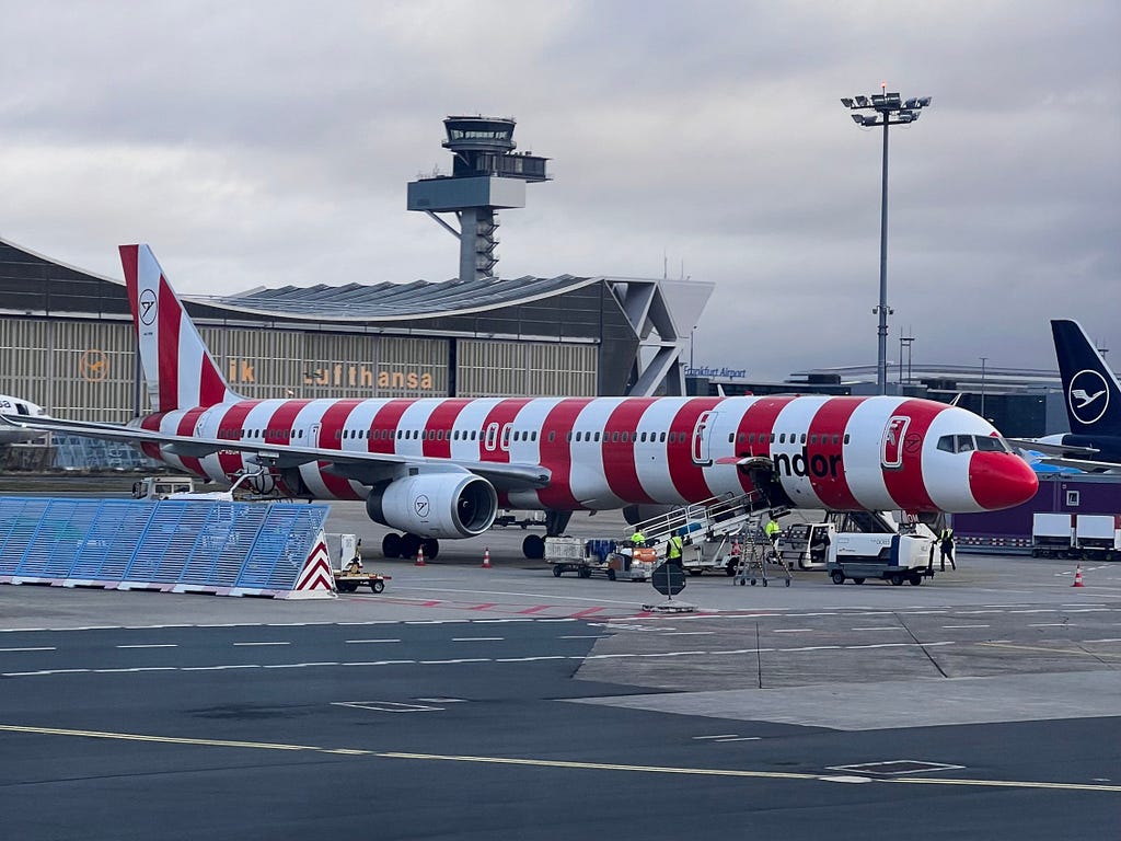 Condor Airbus aircraft at the Frankfurt airport featuring red-and-white stripes livery