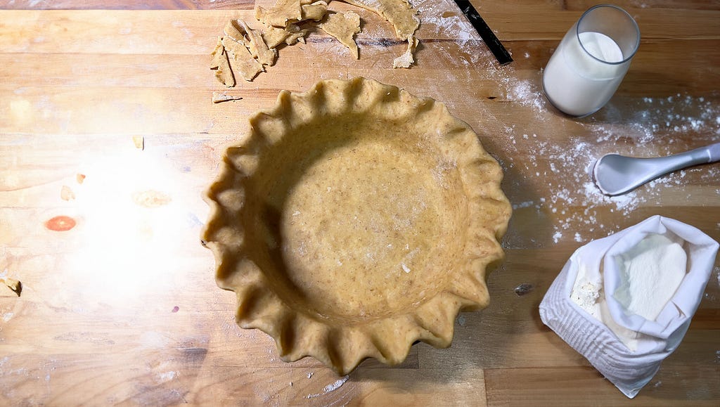 I made a pie and this is the pastry with crimped edges on the worktop before being baked.