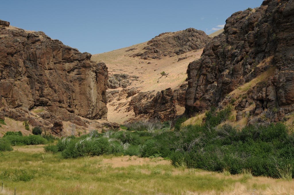 A canyon of twisted and stacked sienna- and rust-colored rocks along the northern road to Jarbidge, Nev., gives hints of shapes and faces in its uneven cliffs.