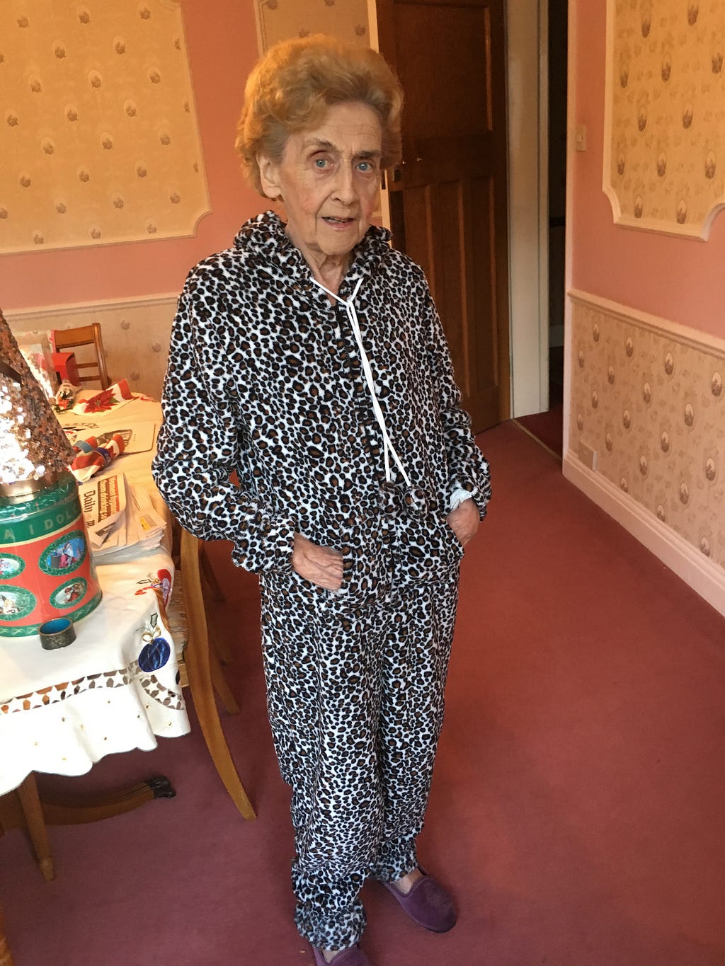 A photograph of my nan Eileen wearing an iconic leopard print onesie.