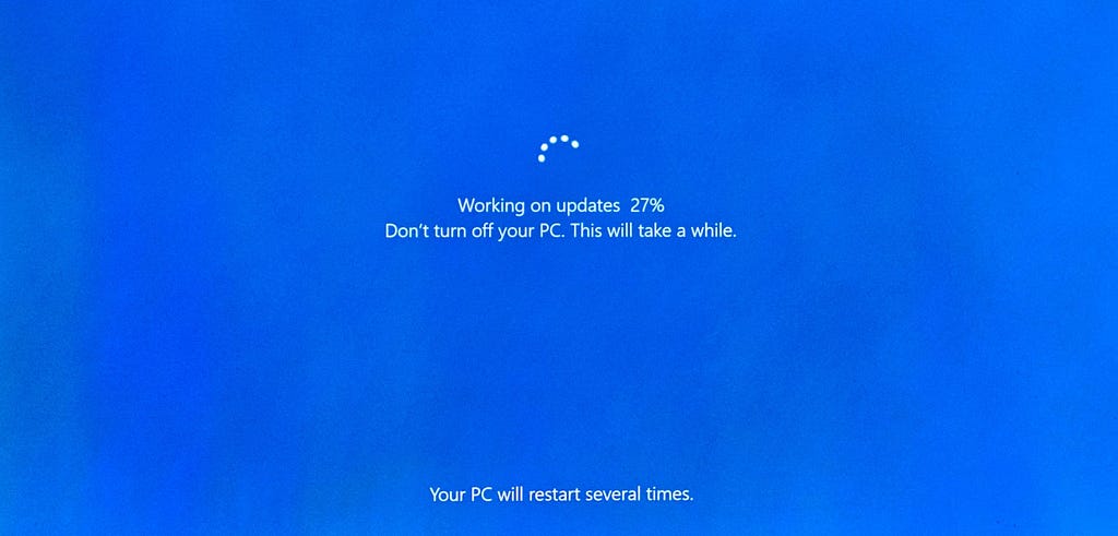 Windows update loading screen at 27%.