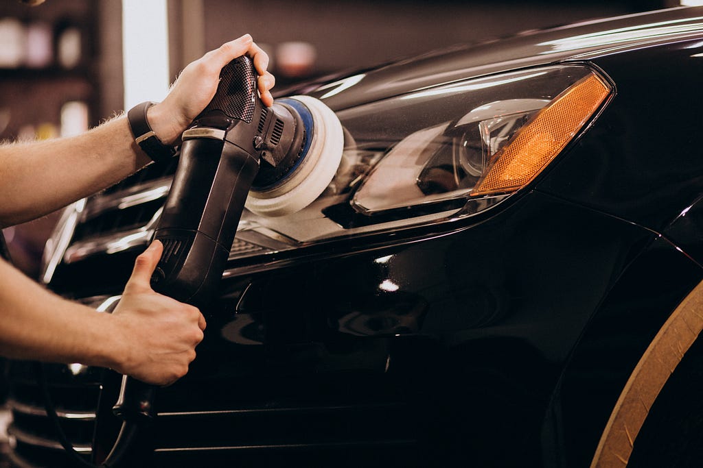 Man Polishing Car with Ceramic Coatings