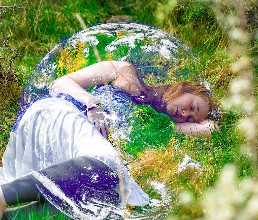 A woman laying in the grass inside mother earth