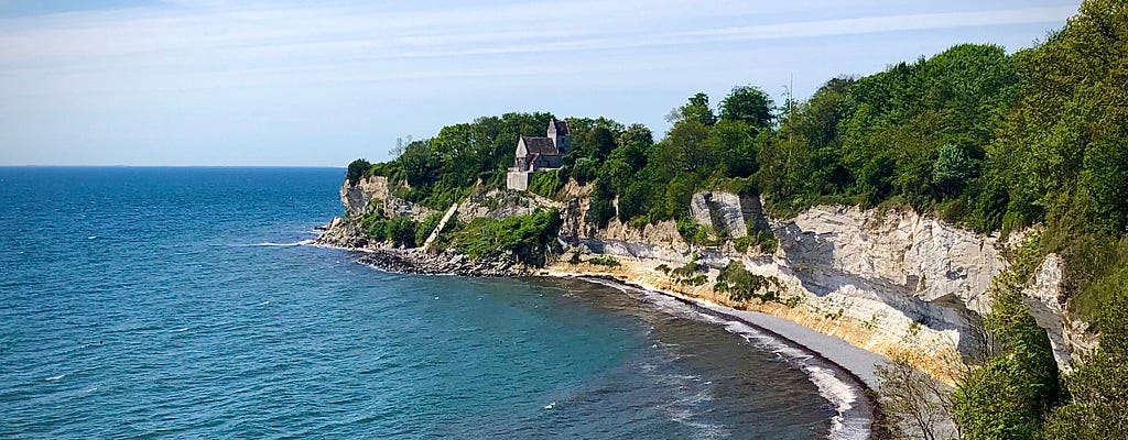 A church on a clif, at a coastlike that is slowly being taken away by the ocean.