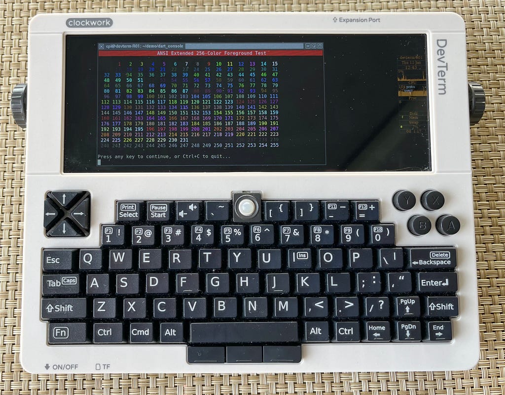 A photo of the ClockworkPi RISC-V portable terminal. This is a small device of approximately the same size as an iPad, but with a miniature keyboard, trackpoint mouse and terminal display.