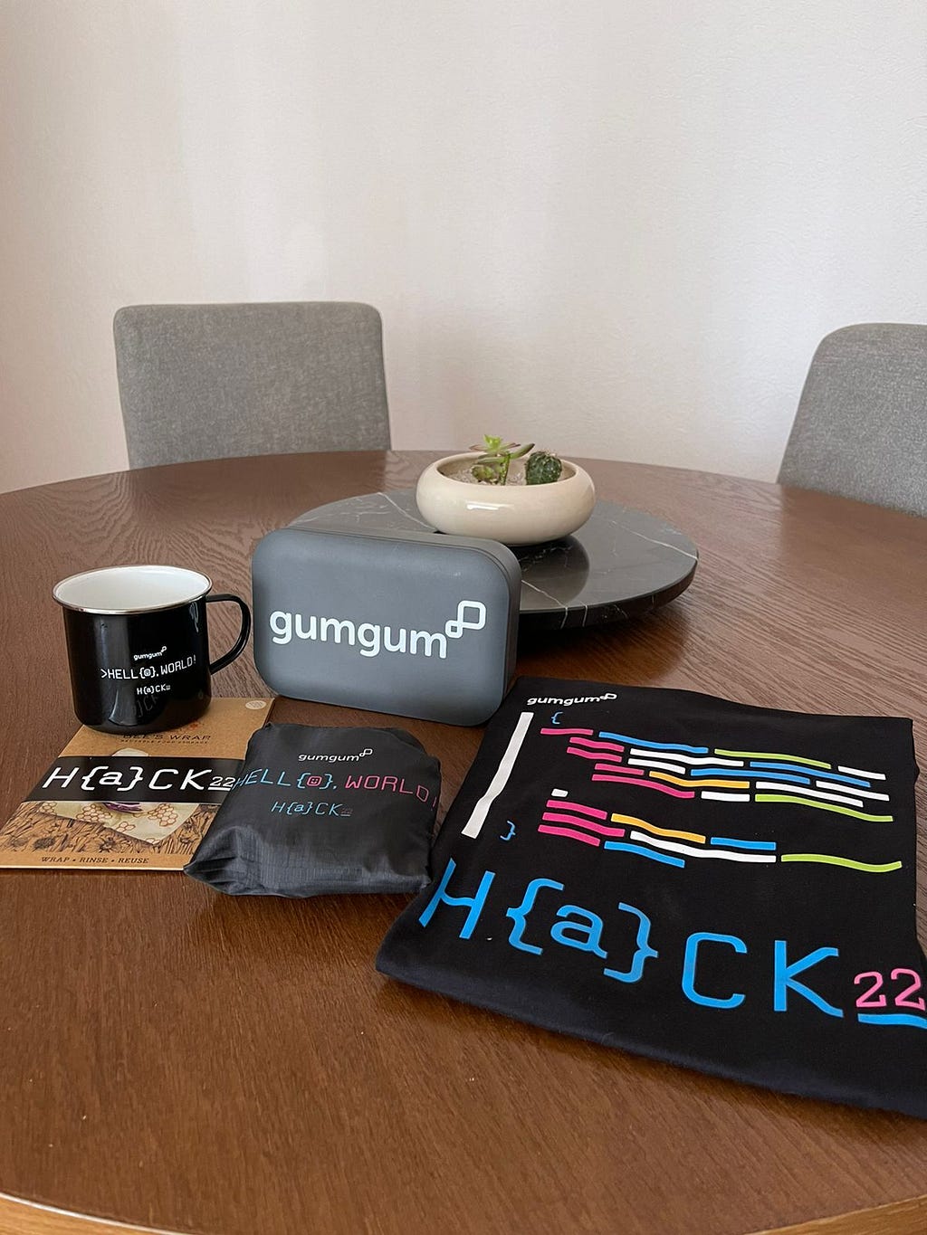 Image of this year’s swag including a mug, beeswax wrapper, t-shirt, reusable shopping bag, and reusable container.