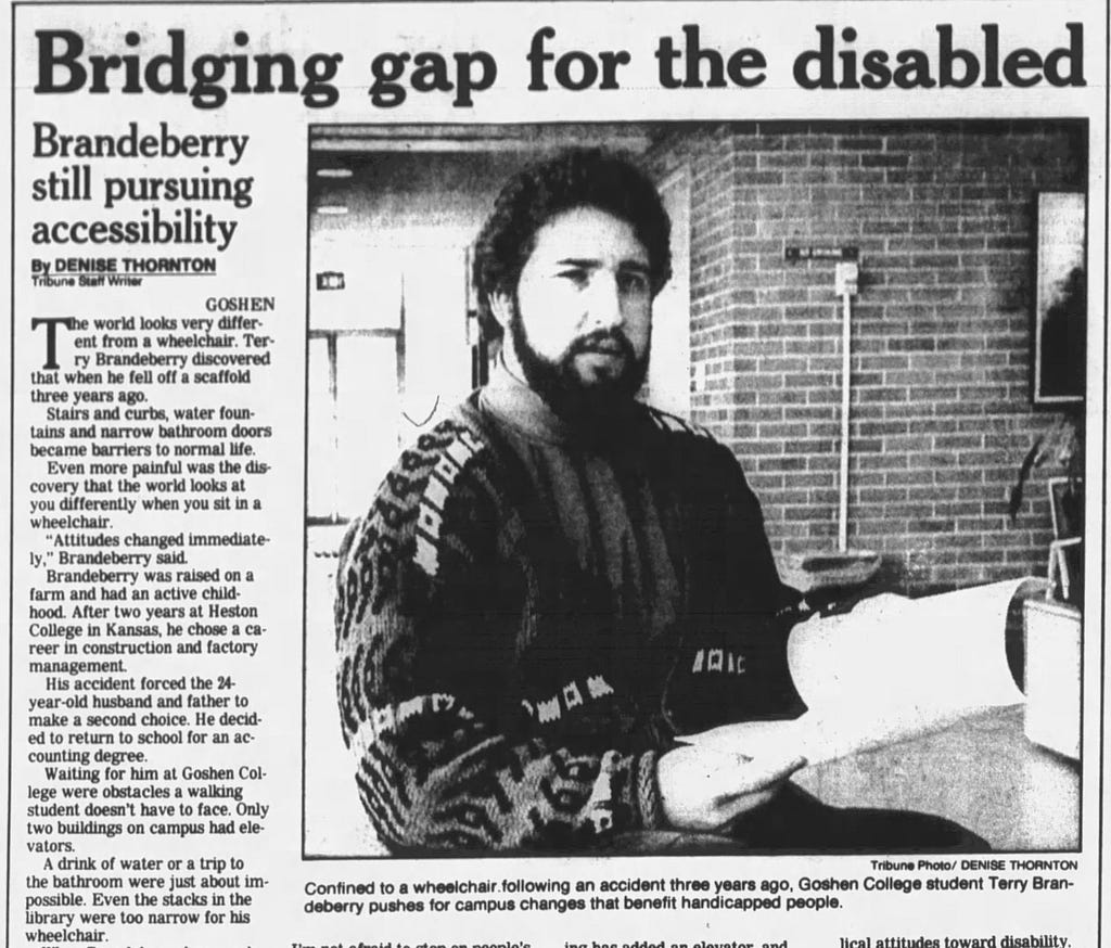 Newspaper article. Headline: “Bridging gap for the disabled” Subhead: “Brandeberry still pursuing accessibility”. The accompanying photo shows my dad holding papers and looking scholarly.