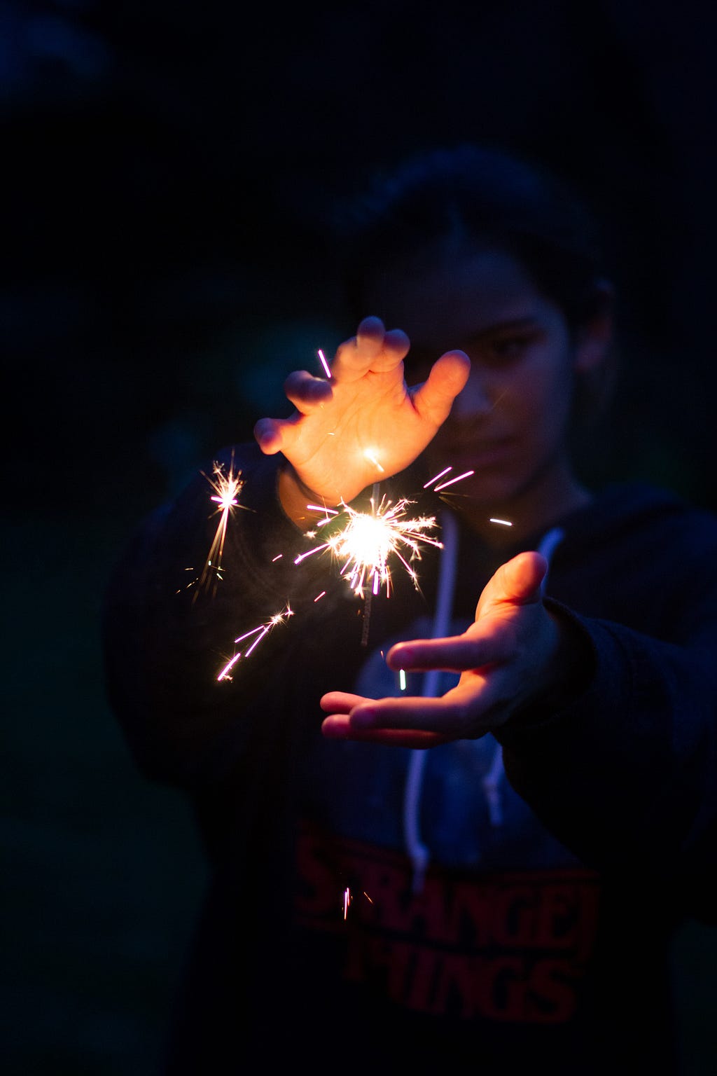 two hands around a sparkler on fire