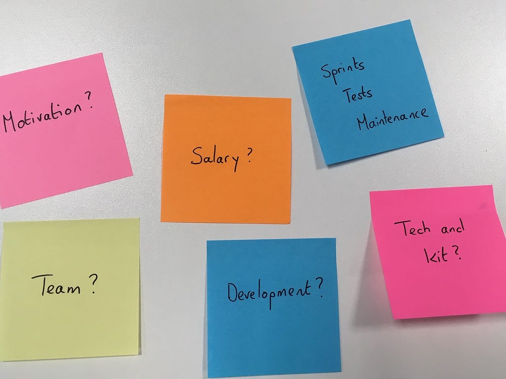 Picture of 6 post it notes with questions. Motivation? Team? Salary? Tech and kit? Development? Sprints, tests, maintenance?