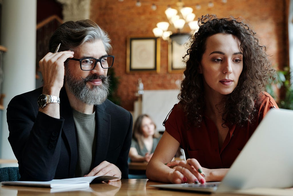 A Picture of Two Individuals Creating a Presentation.