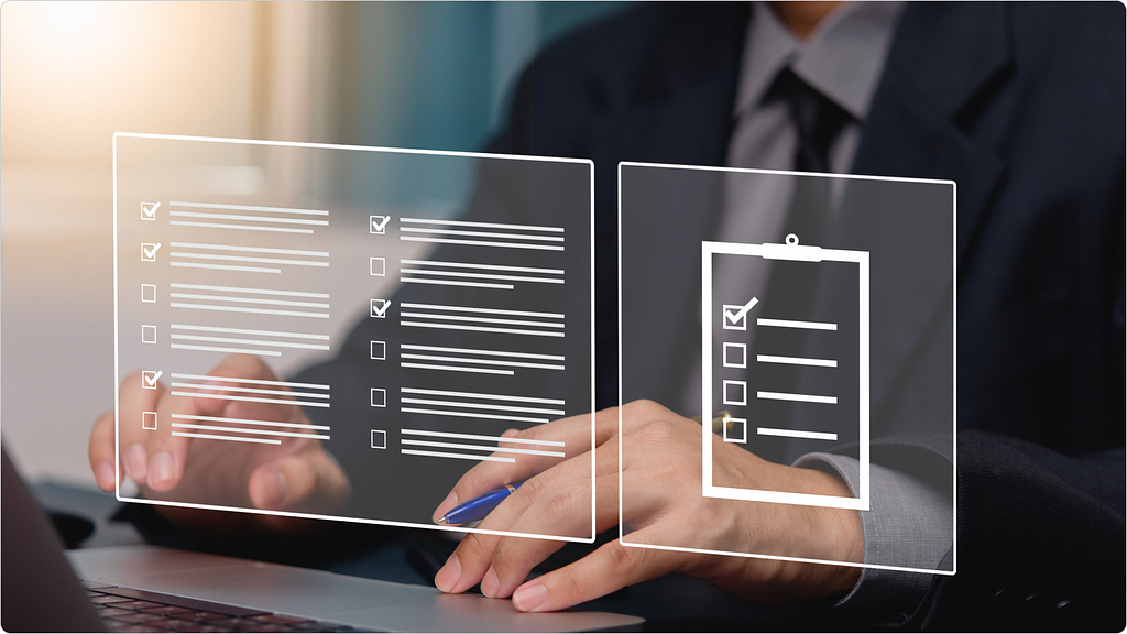 A person in suit using a laptop and working with digital checklists.