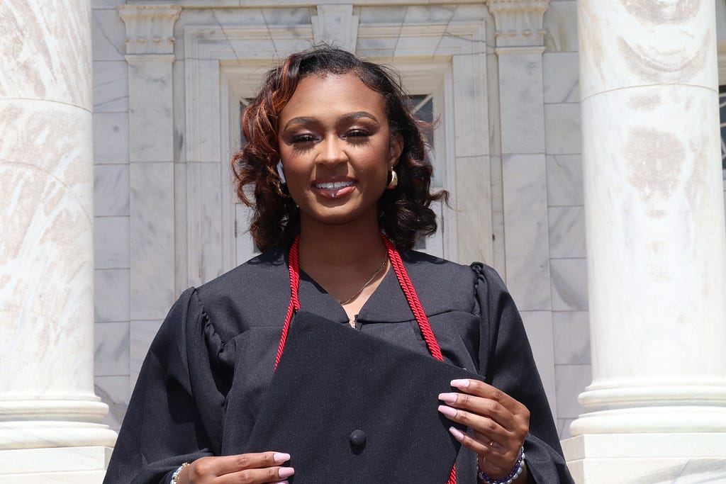 A headshot of Ahnyah Pinkney wearing graduation robes.